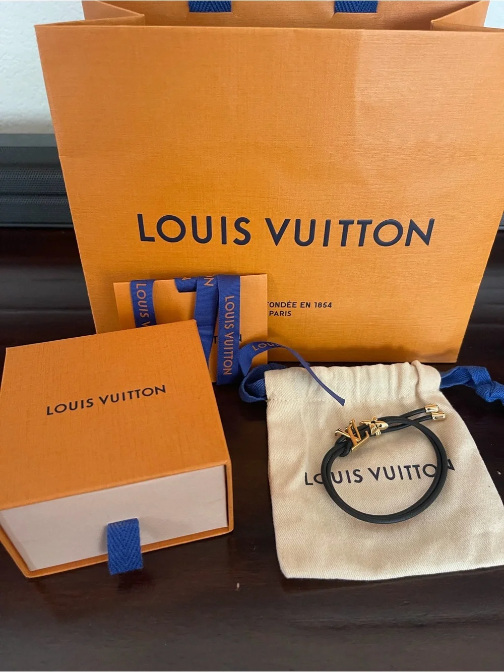 Louis Vuitton Blossom Black Cord Bracelet with Gold LV and Flower. Adjustable.